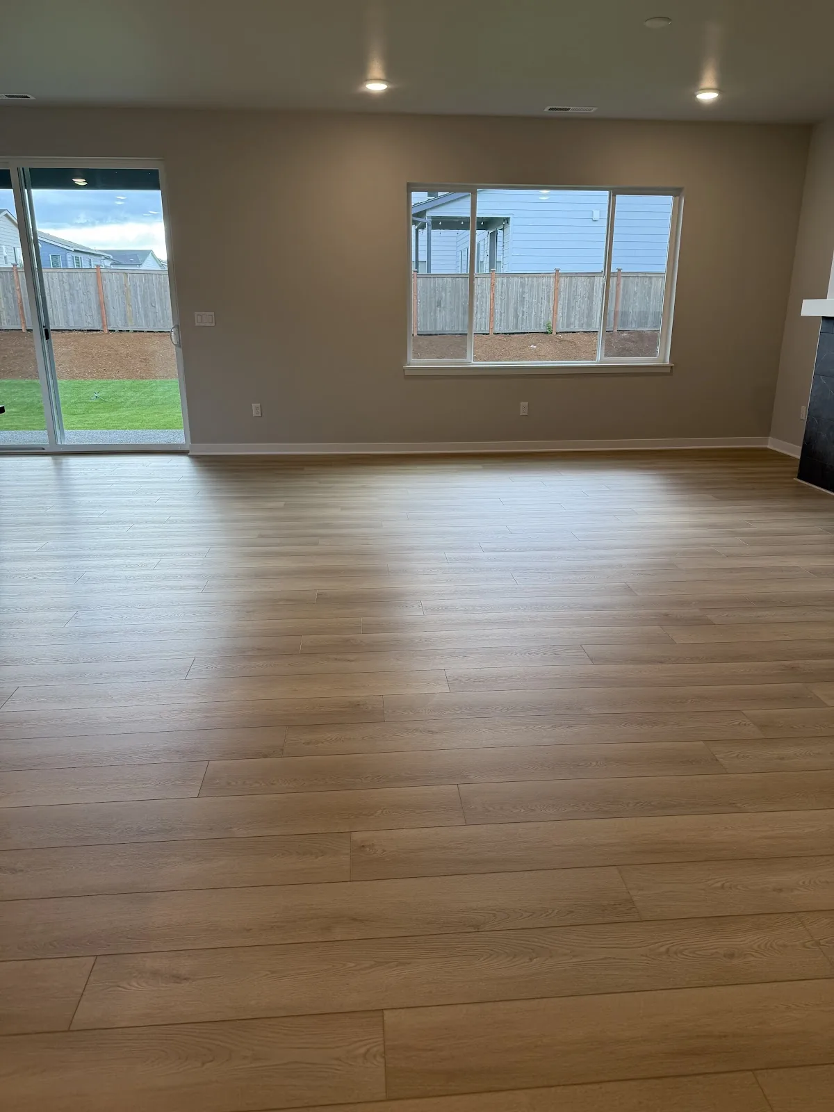 Freshly installed wide-plank flooring in a Snohomish, WA living room by MK Flooring